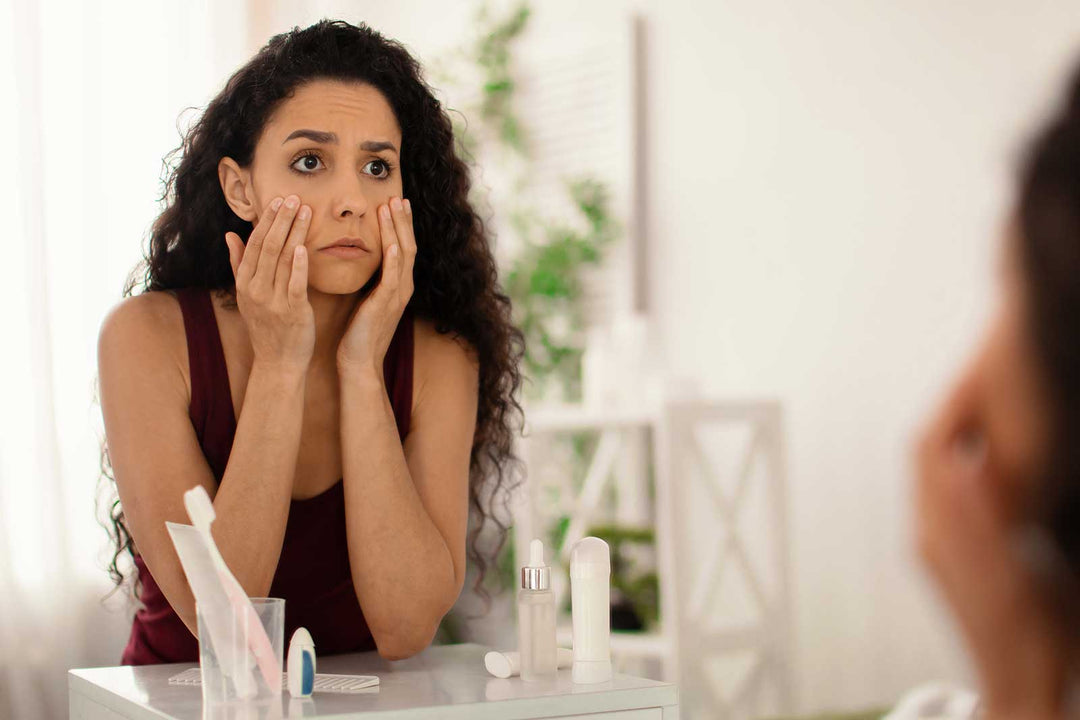 Stock image of a woman looking unhappy with her skin