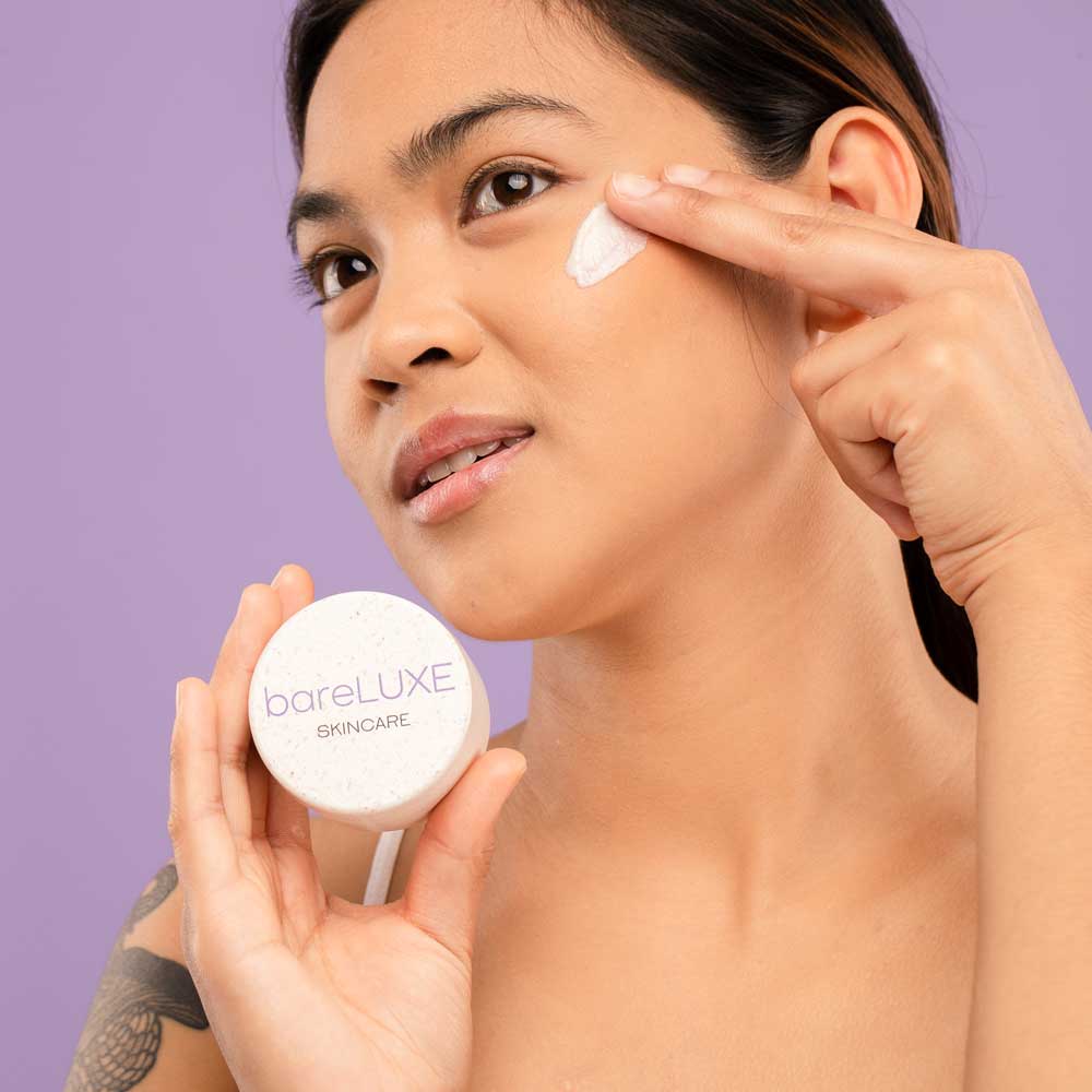 Photo of woman using bareLUXE Crystal Infused Face Polish